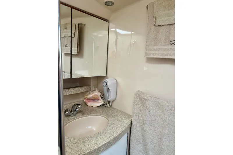 Slide: The Image of Bathroom interior of 2006 Regal Commodore 3560 IO yacht with sink and towels. - 28