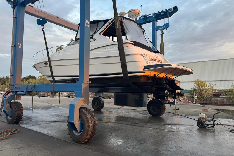 Slide: The Image of 2006 Regal Commodore 3560 IO boat on a lift at a marina. - 3