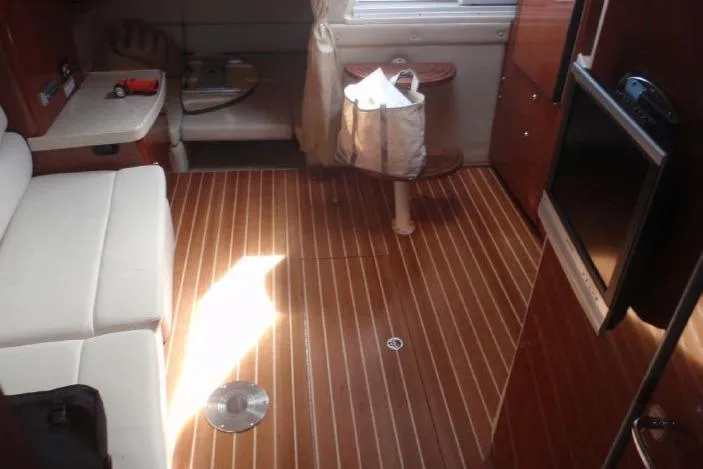 Slide: The Image of Interior of 2006 Regal Commodore 3560 IO yacht with wooden flooring and white seating. - 8
