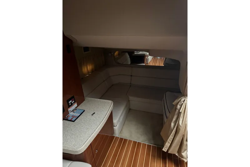 Slide: The Image of Interior of 2006 Regal Commodore 3560 IO yacht with cozy seating and wooden flooring. - 9