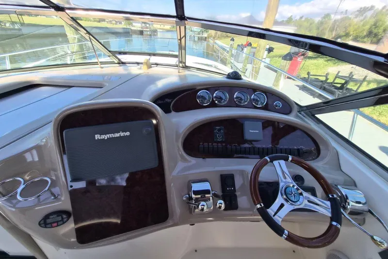 Slide: The Image of 2004 Sea Ray 380 Sundancer helm with Raymarine navigation system and polished steering wheel. - 10