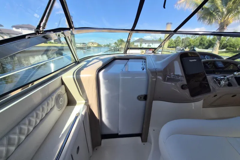 Slide: The Image of 2004 Sea Ray 380 Sundancer helm with scenic waterway view. - 11