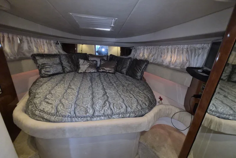 Slide: The Image of Luxurious interior cabin of 2004 Sea Ray 380 Sundancer yacht with plush bedding. - 12