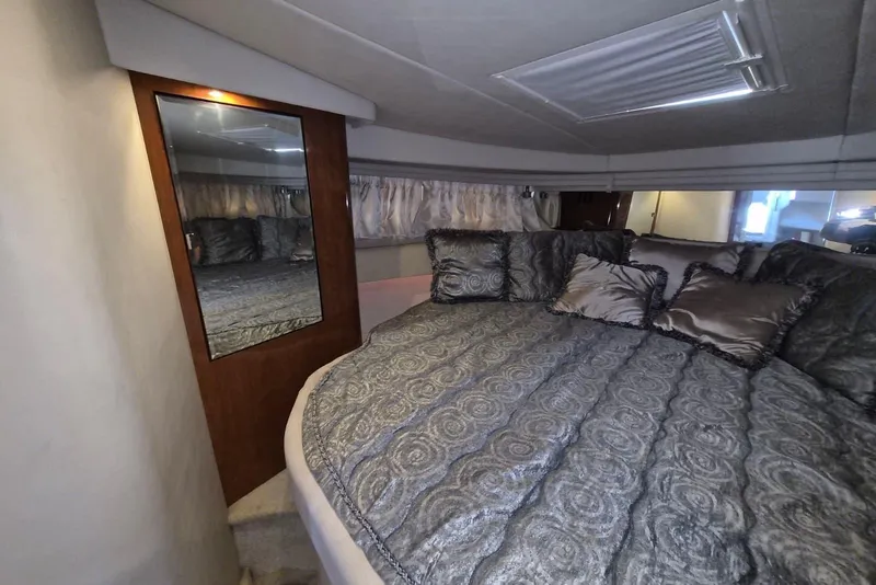 Slide: The Image of Luxurious cabin interior of 2004 Sea Ray 380 Sundancer with plush bedding and mirror. - 13