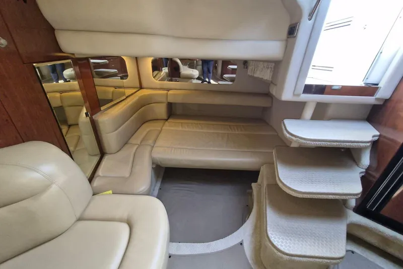 Slide: The Image of Interior of 2004 Sea Ray 380 Sundancer yacht with beige leather seating and carpeted steps. - 15