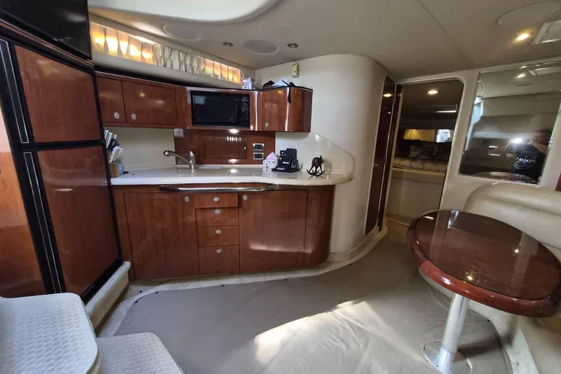 Slide: The Image of Luxurious 2004 Sea Ray 380 Sundancer yacht interior with modern kitchen and dining area. - 16