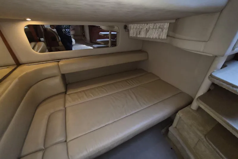 Slide: The Image of Interior cabin of 2004 Sea Ray 380 Sundancer with beige seating and mirror. - 17