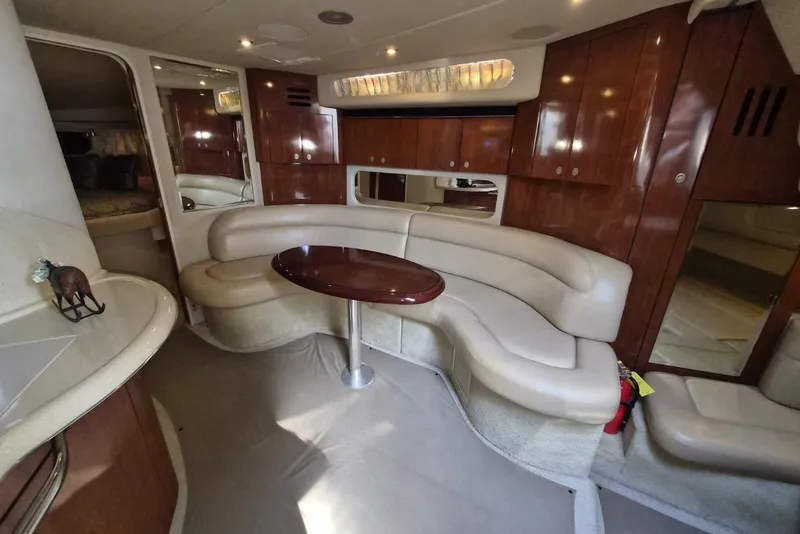 Slide: The Image of Luxurious 2004 Sea Ray 380 Sundancer interior with elegant seating and wooden cabinetry. - 20
