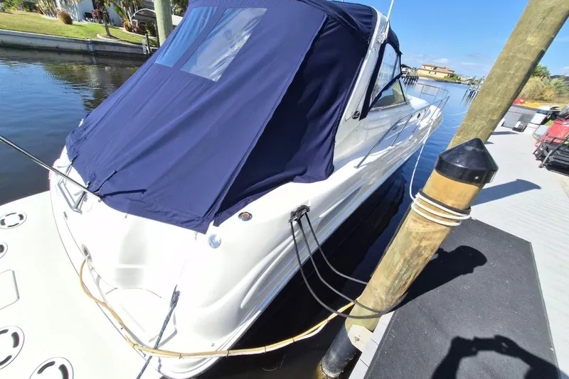 Slide: The Image of 2004 Sea Ray 380 Sundancer docked with blue cover, sunny day. - 24
