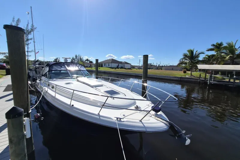 Slide: The Image of 2004 Sea Ray 380 Sundancer yacht docked under clear blue sky. - 26