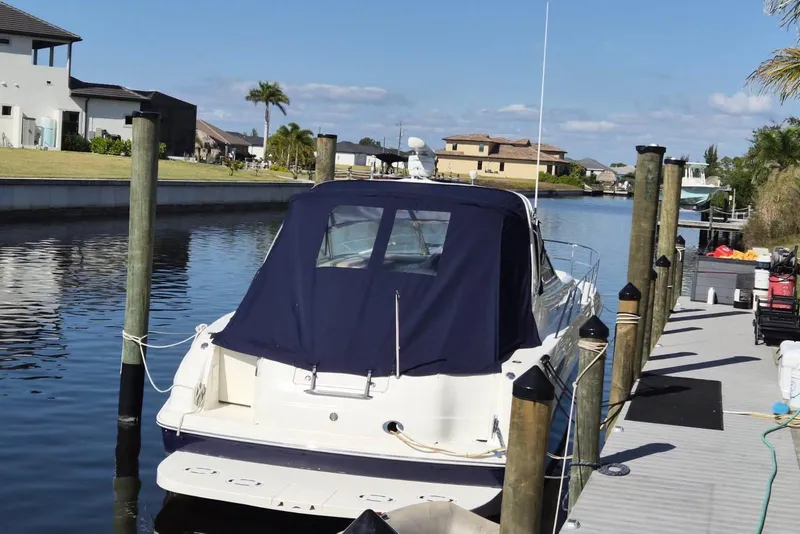Slide: The Image of 2004 Sea Ray 380 Sundancer docked in a scenic canal setting. - 28