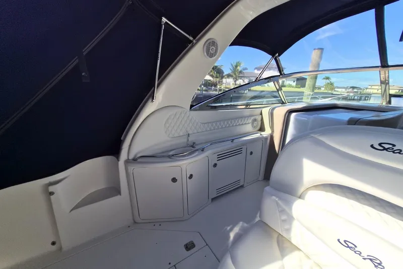 Slide: The Image of 2004 Sea Ray 380 Sundancer interior with seating and cabinetry, featuring a sleek design. - 5