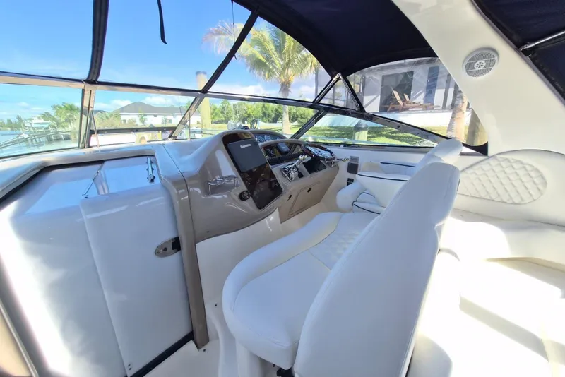 Slide: The Image of 2004 Sea Ray 380 Sundancer helm with luxurious seating and modern controls. - 7