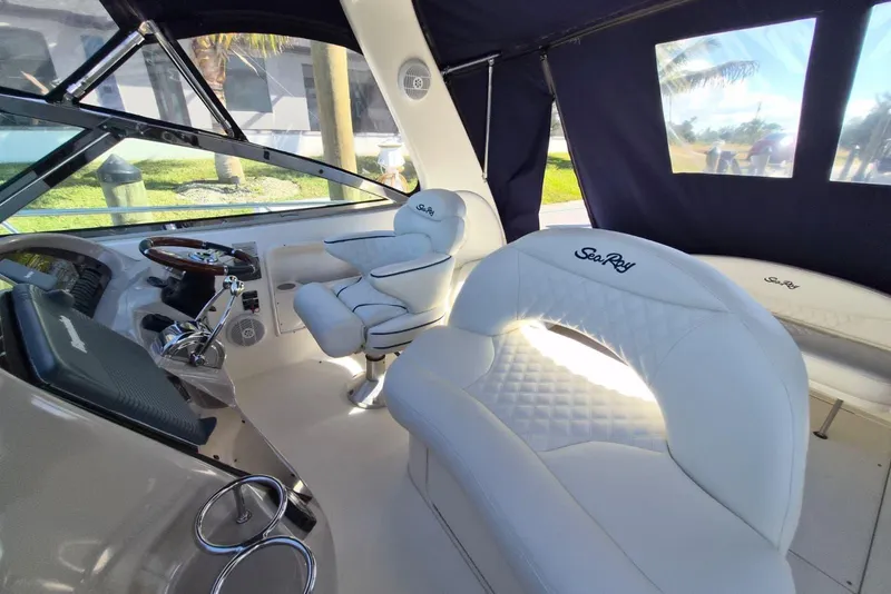 Slide: The Image of Luxurious interior of 2004 Sea Ray 380 Sundancer with plush white seating and helm. - 8