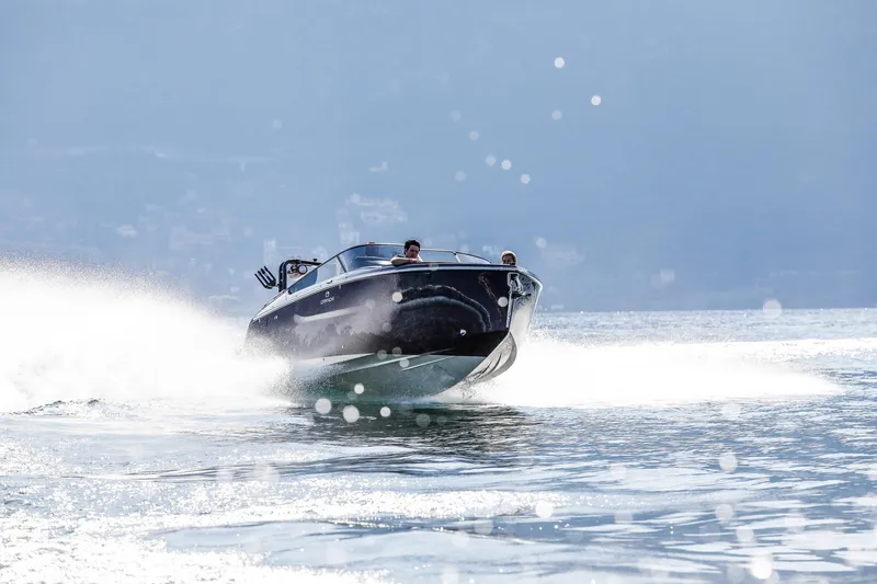 Slide: The Image of 2026 Cranchi E26 Rider speedboat cruising on open water, creating a dynamic wake. - 19