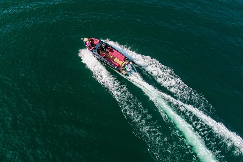 Slide: The Image of Aerial view of 2026 Cranchi E26 Rider speedboat cruising on open water. - 25
