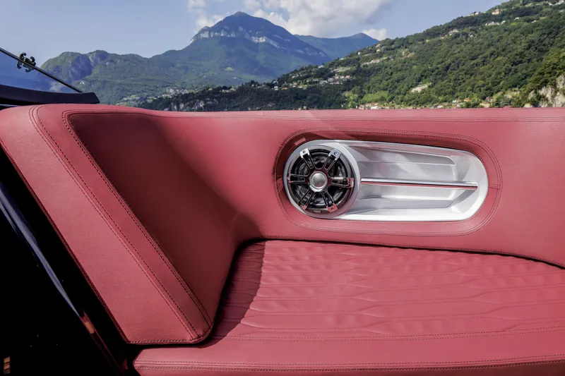 Slide: The Image of Luxurious red seating on 2026 Cranchi E26 Rider boat with scenic mountain backdrop. - 32