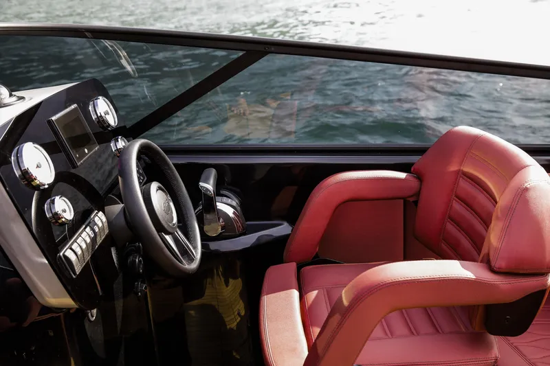 Slide: The Image of 2026 Cranchi E26 Rider boat interior with red leather seat and sleek dashboard. - 35