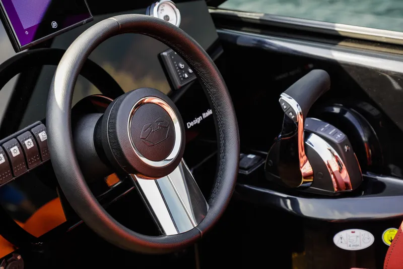 Slide: The Image of Steering wheel and controls of 2026 Cranchi E26 Rider boat cockpit. - 36