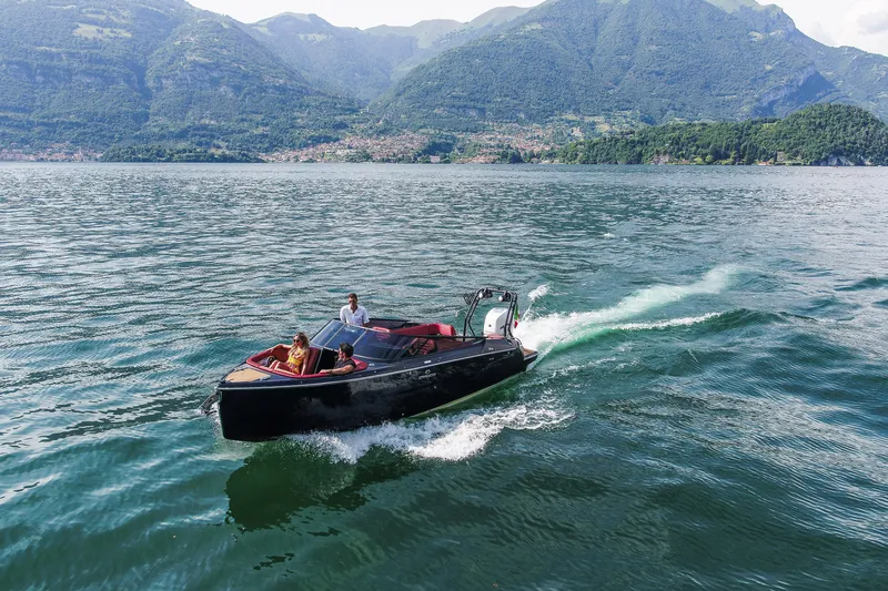 Slide: The Image of 2026 Cranchi E26 Rider cruising on a scenic lake with mountainous backdrop. - 40