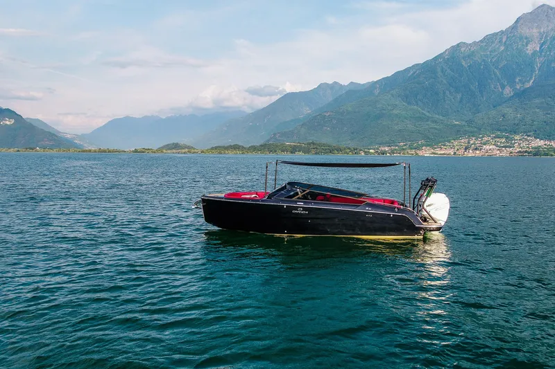 Slide: The Image of 2026 Cranchi E26 Rider boat on scenic lake with mountain backdrop. - 46