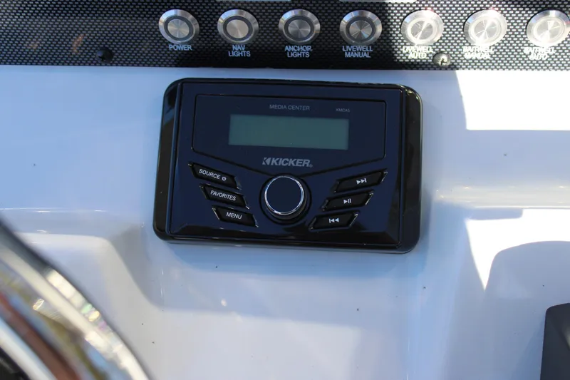 Slide: The Image of Kicker media center on 2026 Xpress H22B Bay boat dashboard with control buttons. - 10
