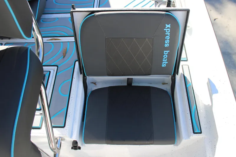 Slide: The Image of 2026 Xpress H22B Bay boat seat with blue accents and logo. - 11