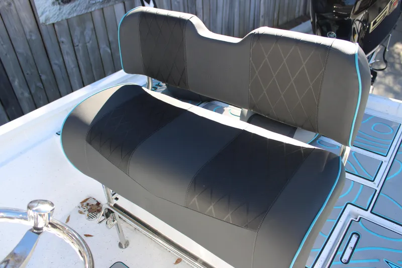 Slide: The Image of 2026 Xpress H22B Bay boat seat with black upholstery and blue trim. - 13