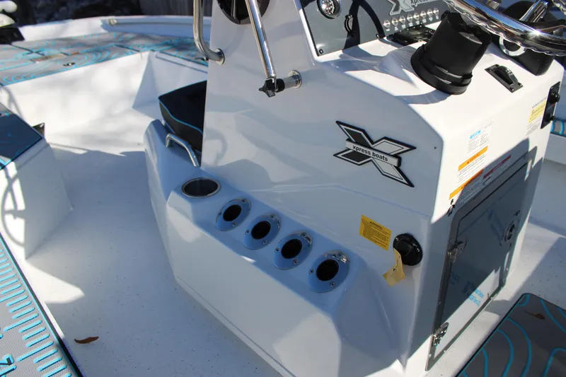 Slide: The Image of 2026 Xpress H22B Bay boat console with steering wheel and rod holders. - 14