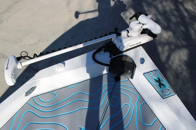 Slide: The Image of 2026 Xpress H22B Bay boat with Minn Kota trolling motor on deck. - 17