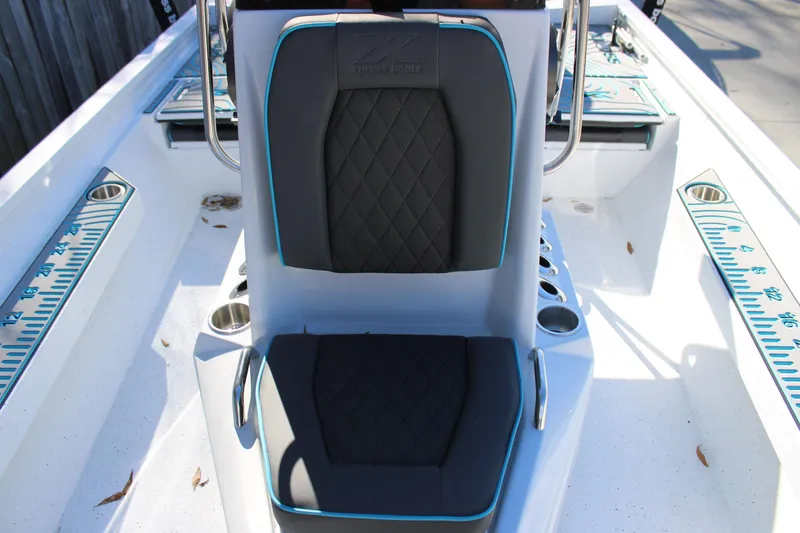 Slide: The Image of 2026 Xpress H22B Bay boat interior with cushioned seating and built-in cup holders. - 19