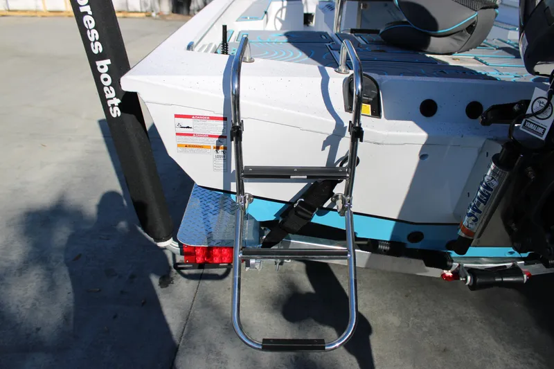 Slide: The Image of 2026 Xpress H22B Bay boat with ladder and motor, docked on concrete surface. - 6