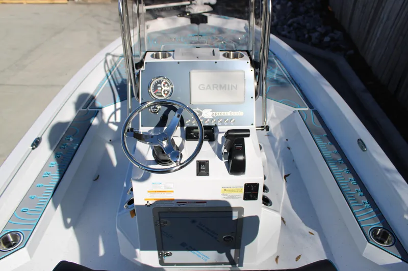 Slide: The Image of 2026 Xpress H22B Bay boat dashboard with Garmin navigation system and steering wheel. - 7