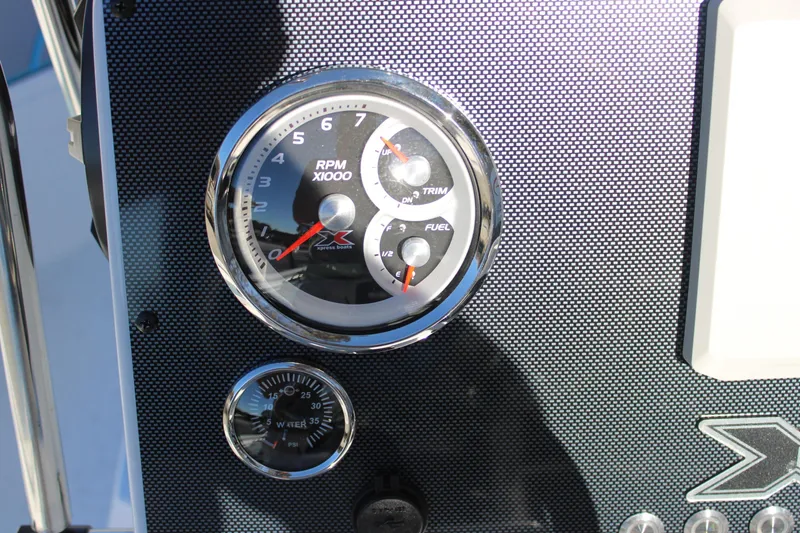 Slide: The Image of Dashboard of 2026 Xpress H22B Bay boat with RPM and fuel gauges. - 8