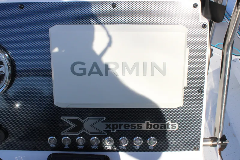 Slide: The Image of Control panel of 2026 Xpress H22B Bay boat featuring Garmin display and switches. - 9