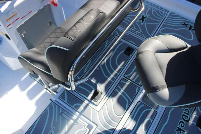 Slide: The Image of 2026 Xpress H20B Bay boat interior with stylish seating and patterned flooring. - 11