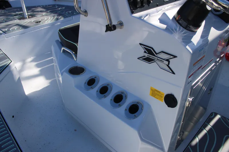 Slide: The Image of 2026 Xpress H20B Bay boat console with rod holders and logo detail. - 15