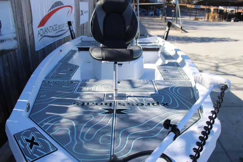 Slide: The Image of 2026 Xpress H20B Bay boat with sleek design and advanced features, docked outdoors. - 26