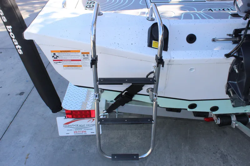 Slide: The Image of 2026 Xpress H20B Bay boat with rear ladder and safety warnings. - 6