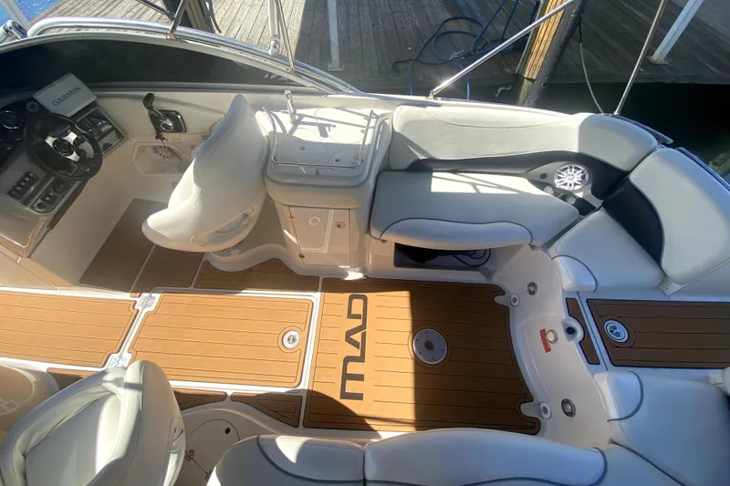 Slide: The Image of Interior of a 2006 Monterey 263 Explorer Sport boat with seating and control panel. - 16