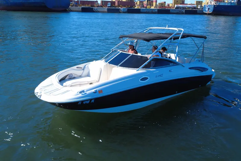 Slide: The Image of 2006 Monterey 263 Explorer Sport boat cruising on water with passengers. - 2