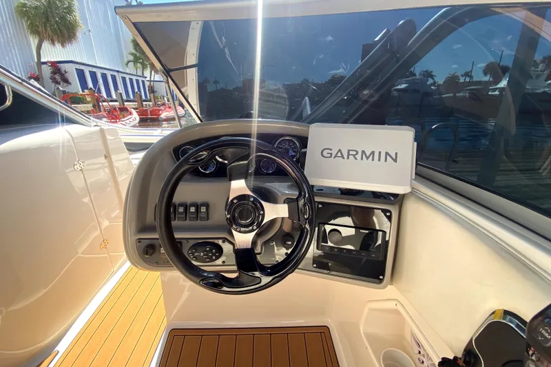 Slide: The Image of 2006 Monterey 263 Explorer Sport dashboard with Garmin navigation system, steering wheel, and controls. - 25