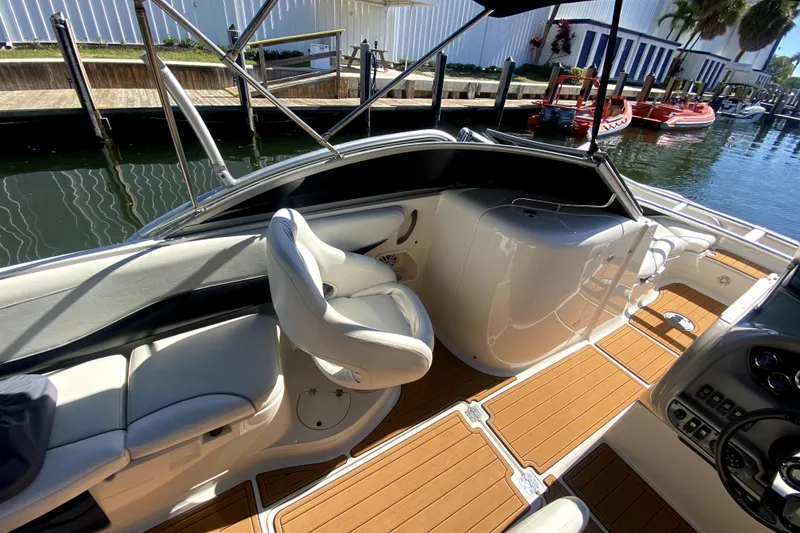 Slide: The Image of 2006 Monterey 263 Explorer Sport boat interior with seating and wooden flooring. - 28