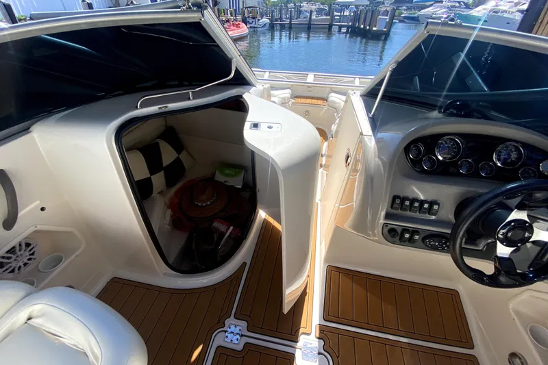 Slide: The Image of 2006 Monterey 263 Explorer Sport boat interior with helm and cabin, docked at marina. - 29