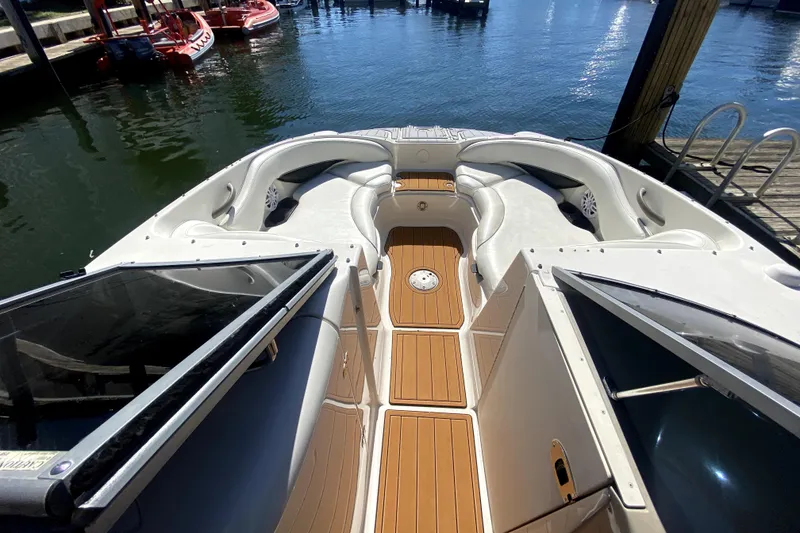 Slide: The Image of 2006 Monterey 263 Explorer Sport boat interior with seating and wood flooring. - 33