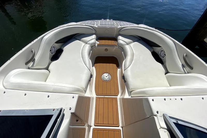 Slide: The Image of 2006 Monterey 263 Explorer Sport boat interior with white seating and wood flooring. - 34