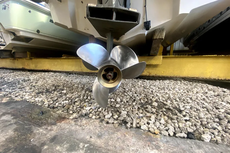 Slide: The Image of Propeller of a 2006 Monterey 263 Explorer Sport boat on gravel surface. - 44