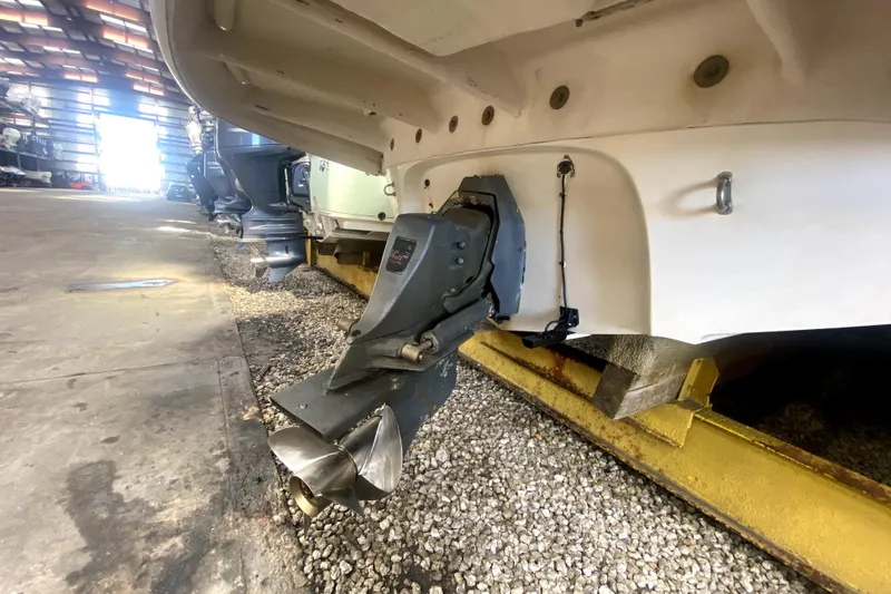Slide: The Image of 2006 Monterey 263 Explorer Sport boat in storage, showing propeller and stern drive. - 45