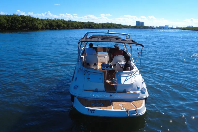 Slide: The Image of 2006 Monterey 263 Explorer Sport boat cruising on a sunny day with passengers onboard. - 6