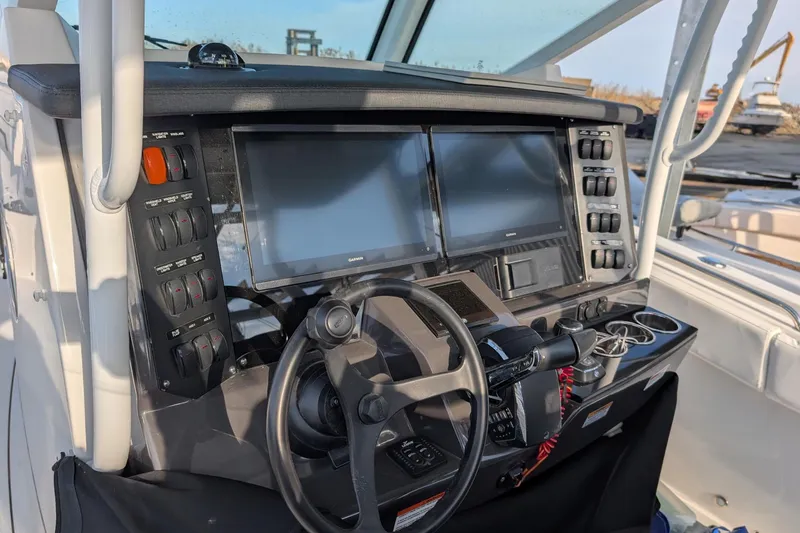 Slide: The Image of 2024 Blackfin 332 CC helm with dual screens and control panel. - 11